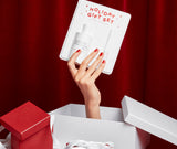 Holiday Gift Set 2023 holded by hand out of a christmas gift Juliette has a gun